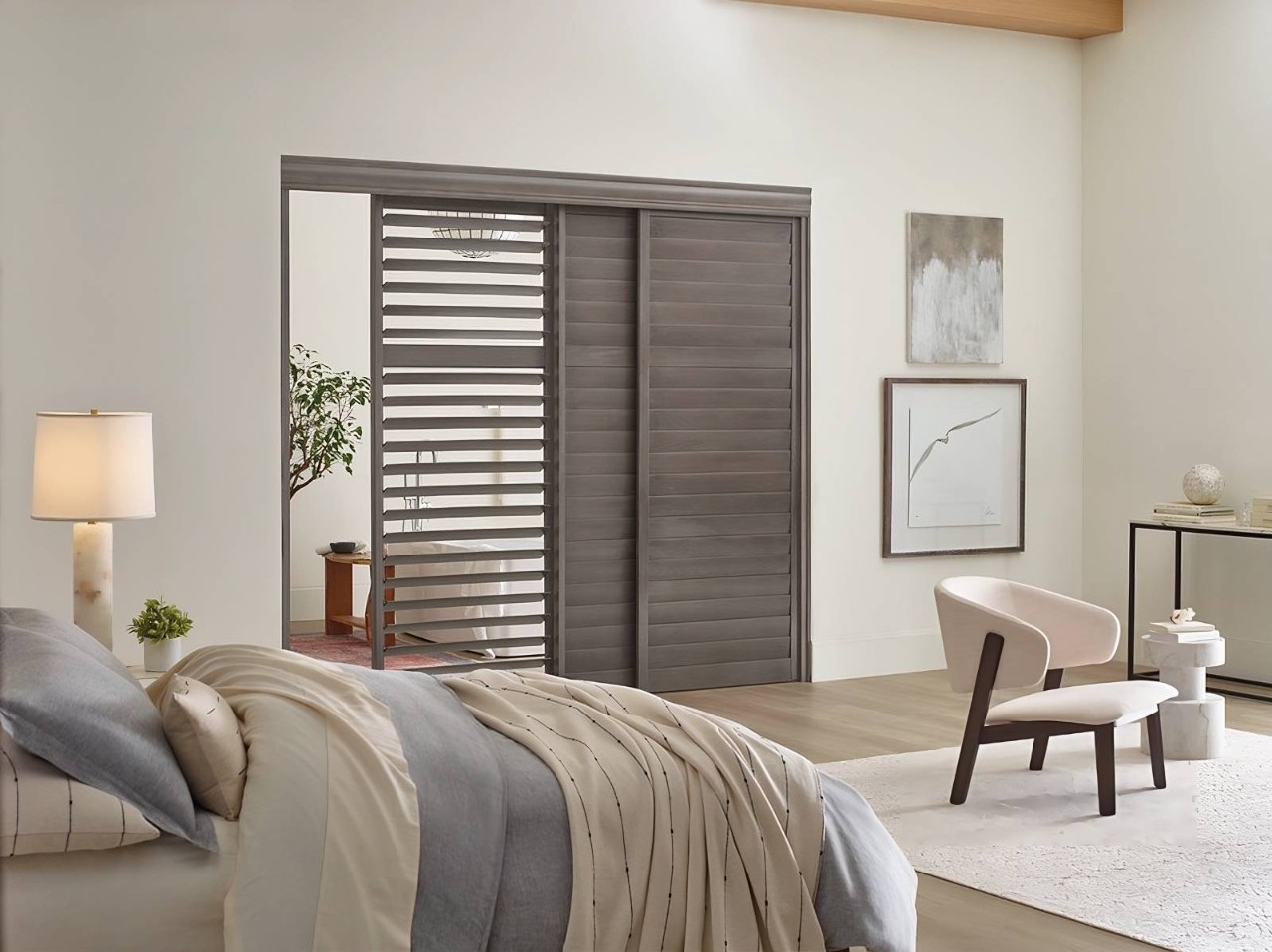 Hunter Douglas Heritance® Hardwood Shutters being used as a room divider in a bedroom near Ocean City, MD